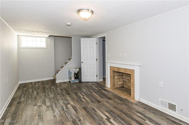 234 E 218th St, Euclid, OH 44123 - unfurnished living room with wood finished floors, stairs, and a tiled fireplace