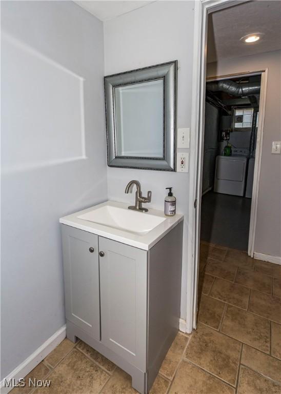 234 E 218th St, Euclid, OH 44123 - bathroom featuring washer / clothes dryer and vanity