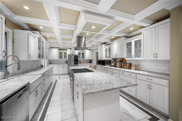 8985 Williams Rd, Chardon, OH 44024 - kitchen with stainless steel appliances, island exhaust hood, a center island, white cabinets, and decorative backsplash