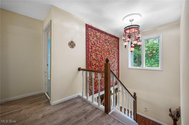 8985 Williams Rd, Chardon, OH 44024 - stairway with wood finished floors and a chandelier