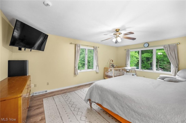 8985 Williams Rd, Chardon, OH 44024 - bedroom with multiple windows, wood finished floors, and a ceiling fan