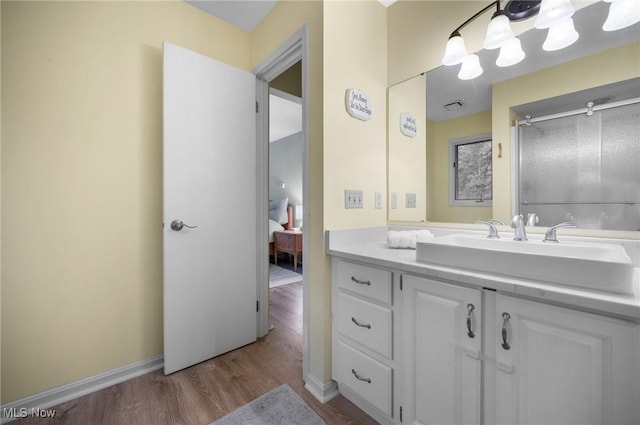 8985 Williams Rd, Chardon, OH 44024 - ensuite bathroom featuring wood finished floors, vanity, and a shower with door