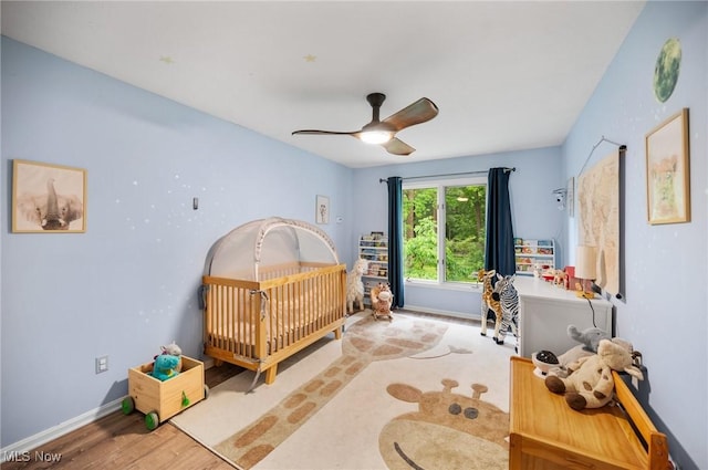 8985 Williams Rd, Chardon, OH 44024 - bedroom featuring a crib, wood finished floors, and ceiling fan
