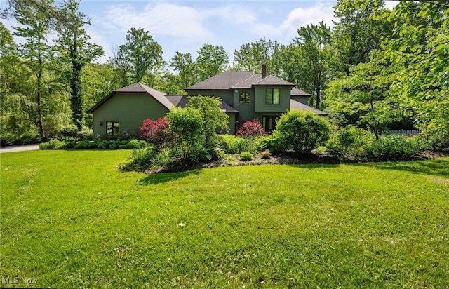 8985 Williams Rd, Chardon, OH 44024 - view of front of house featuring a front lawn and a chimney