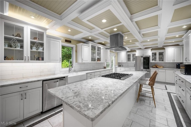 8985 Williams Rd, Chardon, OH 44024 - kitchen with island range hood, stainless steel appliances, a kitchen island, coffered ceiling, and decorative backsplash