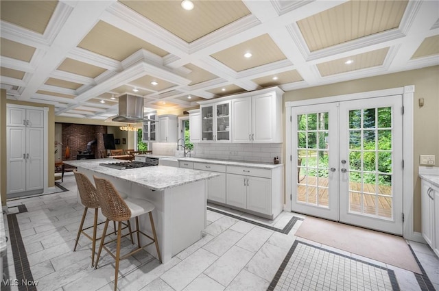 8985 Williams Rd, Chardon, OH 44024 - kitchen with coffered ceiling, island exhaust hood, a kitchen bar, a kitchen island, and french doors