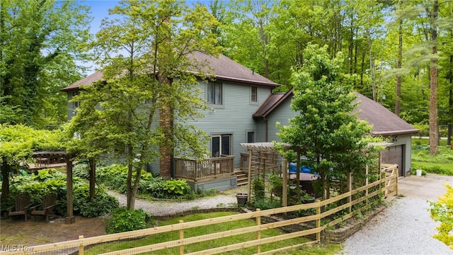 8985 Williams Rd, Chardon, OH 44024 - view of front facade featuring driveway, a wooden deck, and an attached garage