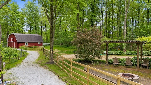 8985 Williams Rd, Chardon, OH 44024 - view of yard with a barn, an outdoor fire pit, an outbuilding, and driveway