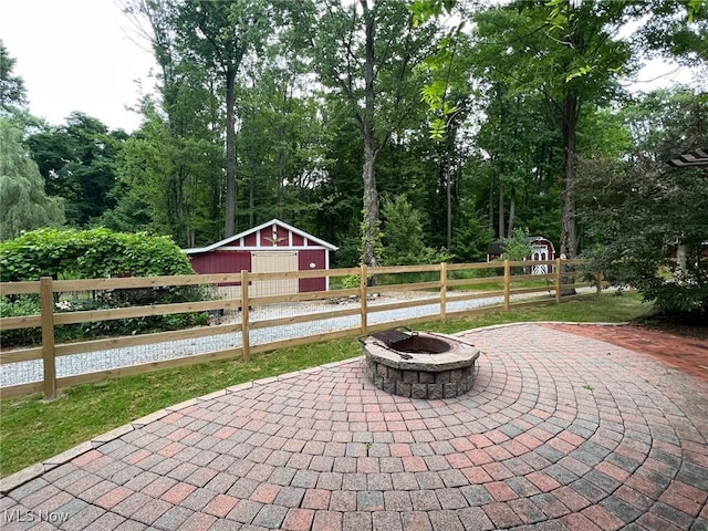 8985 Williams Rd, Chardon, OH 44024 - view of patio featuring an outdoor fire pit and an outdoor structure