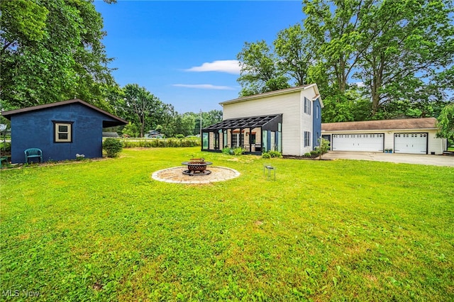 5411 W Heisley Rd, Mentor, OH 44060 - view of green lawn featuring a fire pit, a garage, and an outdoor structure