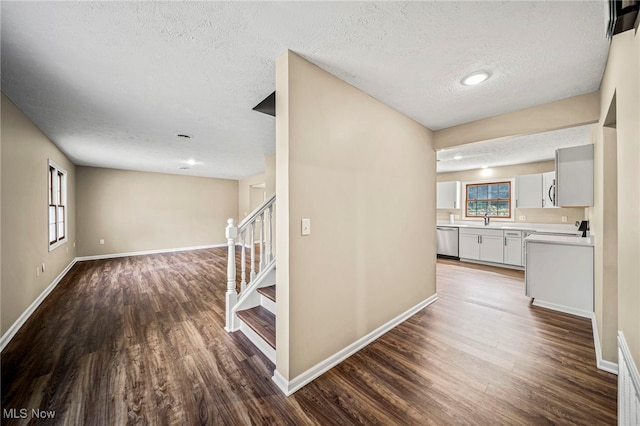 5411 W Heisley Rd, Mentor, OH 44060 - hall with dark wood finished floors, a textured ceiling, plenty of natural light, and stairs