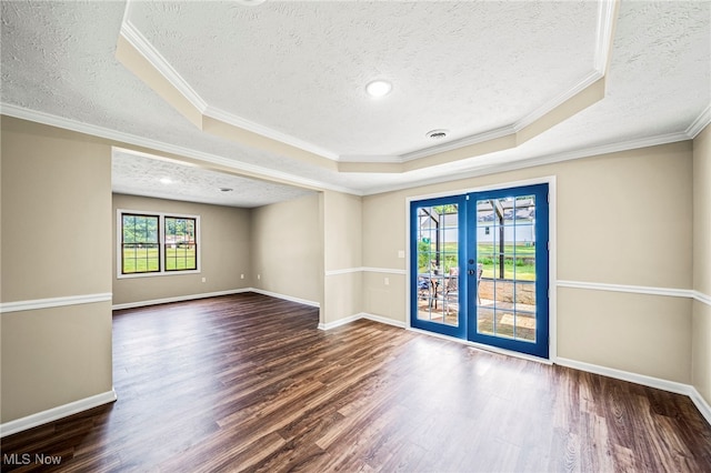 5411 W Heisley Rd, Mentor, OH 44060 - spare room featuring a textured ceiling, french doors, a raised ceiling, wood finished floors, and ornamental molding