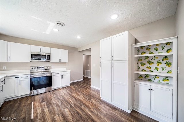 5411 W Heisley Rd, Mentor, OH 44060 - kitchen featuring stainless steel appliances, dark wood-style flooring, white cabinetry, light countertops, and a textured ceiling