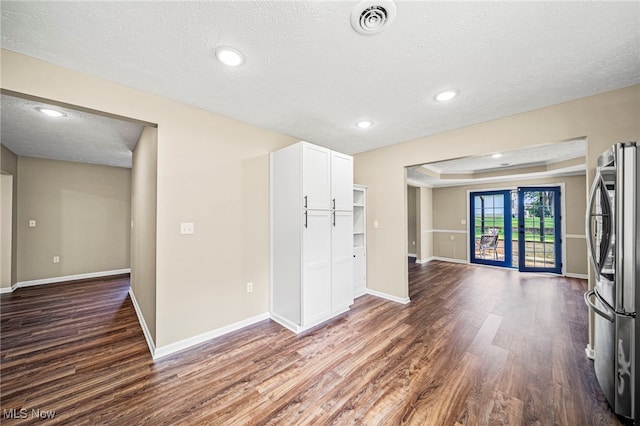5411 W Heisley Rd, Mentor, OH 44060 - unfurnished living room featuring dark wood-type flooring, a textured ceiling, recessed lighting, and a tray ceiling