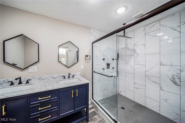 5411 W Heisley Rd, Mentor, OH 44060 - full bath featuring a textured ceiling, a marble finish shower, double vanity, wood finished floors, and recessed lighting