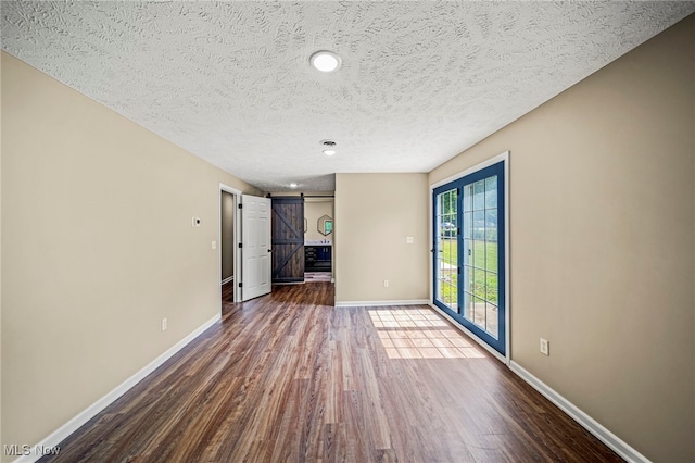 5411 W Heisley Rd, Mentor, OH 44060 - unfurnished living room with a barn door, wood finished floors, a textured ceiling, and recessed lighting