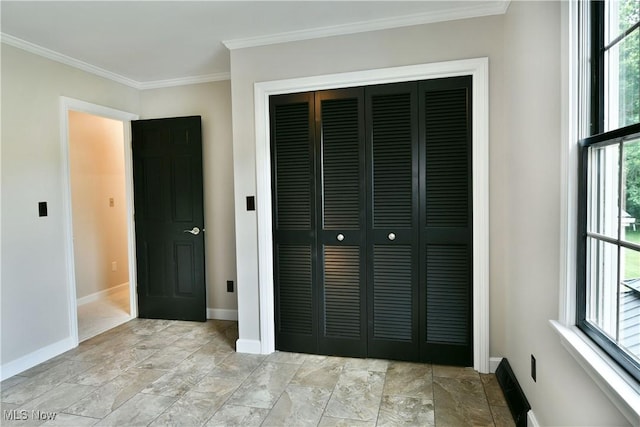 191 Maple Leaf Dr, Hubbard, OH 44425 - unfurnished bedroom with a closet, ornamental molding, and light stone finish flooring