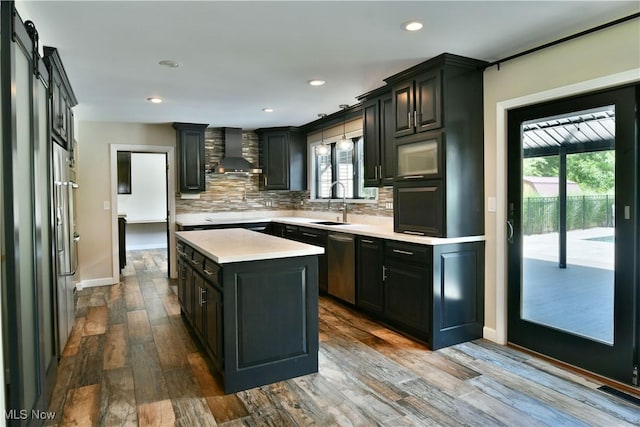 191 Maple Leaf Dr, Hubbard, OH 44425 - kitchen featuring wall chimney exhaust hood, dishwasher, light countertops, a kitchen island, and healthy amount of natural light