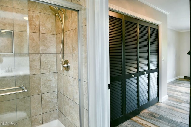 191 Maple Leaf Dr, Hubbard, OH 44425 - full bathroom featuring ornamental molding, a stall shower, and wood finished floors
