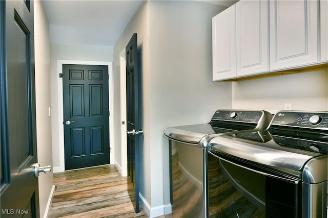 191 Maple Leaf Dr, Hubbard, OH 44425 - laundry area with washer and clothes dryer, cabinet space, and wood finished floors