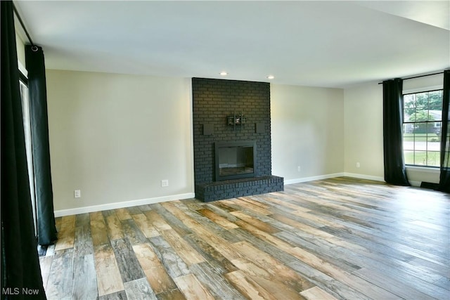 191 Maple Leaf Dr, Hubbard, OH 44425 - unfurnished living room featuring wood finished floors, a brick fireplace, and recessed lighting