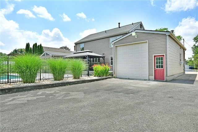 191 Maple Leaf Dr, Hubbard, OH 44425 - view of side of home featuring a garage and asphalt driveway