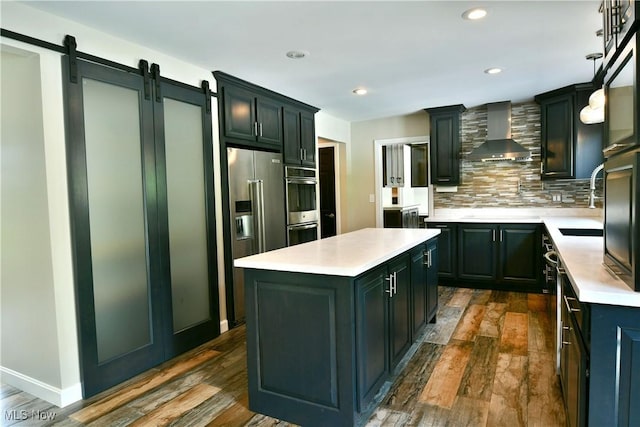 191 Maple Leaf Dr, Hubbard, OH 44425 - kitchen with wall chimney exhaust hood, stainless steel appliances, light countertops, a center island, and tasteful backsplash