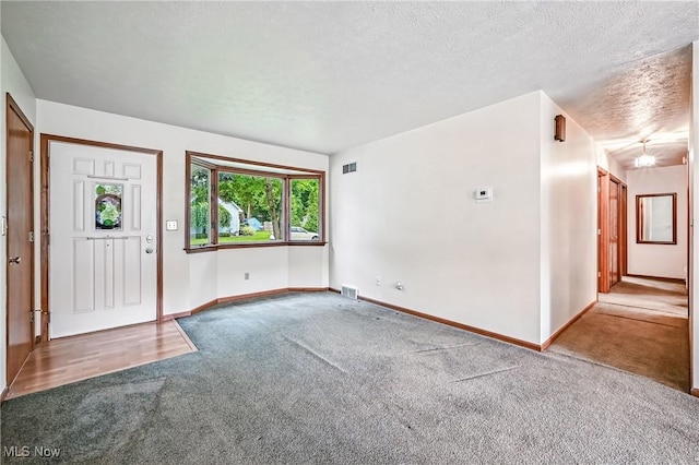 114 Corrin Cir, Cortland, OH 44410 - carpeted entrance foyer featuring baseboards and a textured ceiling
