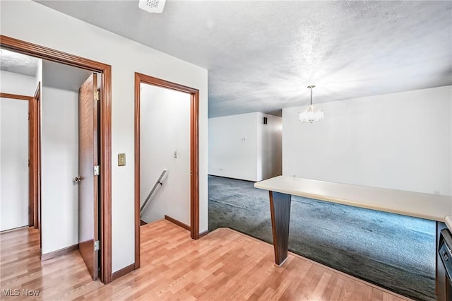 114 Corrin Cir, Cortland, OH 44410 - hallway with an upstairs landing, light wood-style flooring, and a chandelier