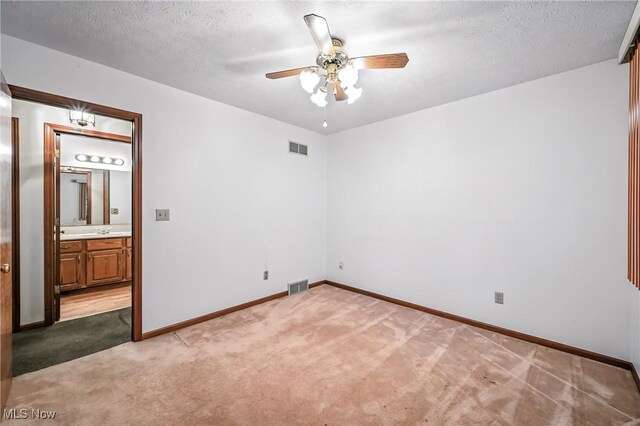 114 Corrin Cir, Cortland, OH 44410 - spare room with light colored carpet, a ceiling fan, and a textured ceiling