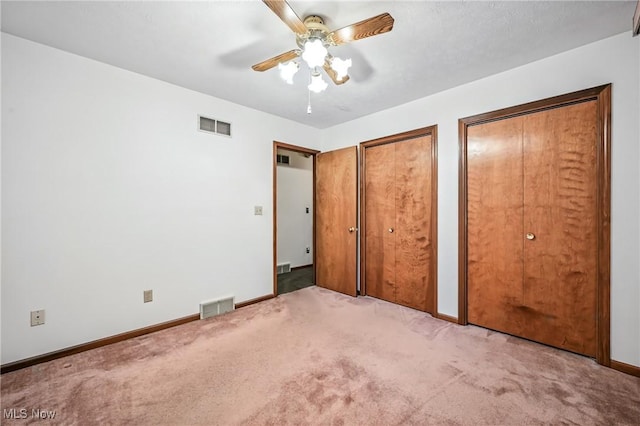 114 Corrin Cir, Cortland, OH 44410 - unfurnished bedroom with multiple closets, carpet, and a ceiling fan