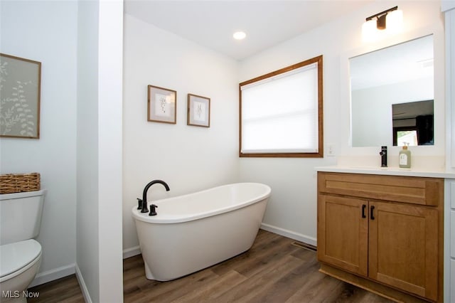 18259 William Dr, Doylestown, OH 44230 - full bathroom with a freestanding tub, vanity, wood finished floors, and recessed lighting