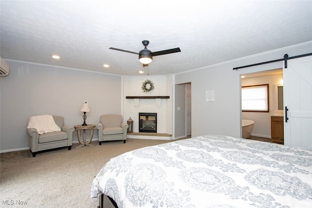 18259 William Dr, Doylestown, OH 44230 - carpeted bedroom featuring recessed lighting, a barn door, ornamental molding, a brick fireplace, and a wall mounted AC