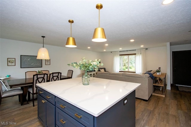 18259 William Dr, Doylestown, OH 44230 - kitchen featuring blue cabinets, dark wood-style floors, a textured ceiling, light countertops, and a center island