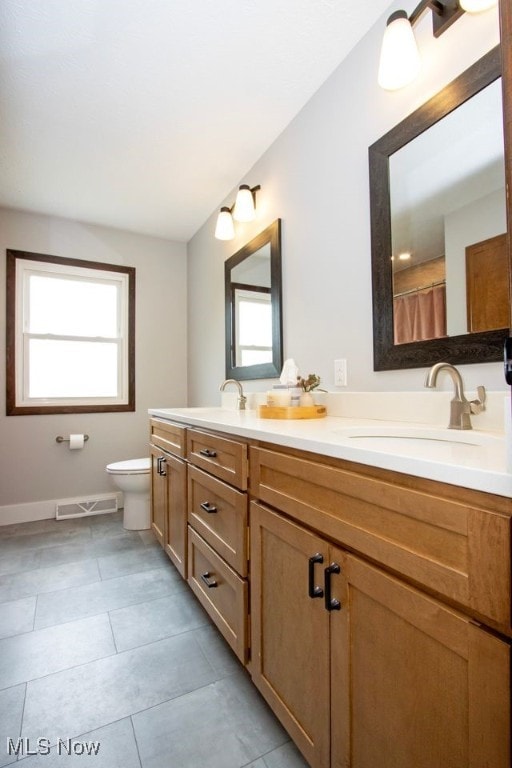 18259 William Dr, Doylestown, OH 44230 - full bathroom featuring double vanity, plenty of natural light, and tile patterned flooring