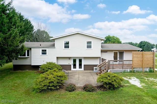 18259 William Dr, Doylestown, OH 44230 - back of house featuring a lawn, a patio area, a deck, and roof with shingles