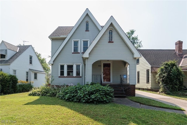 3817 Washington Park Blvd, Newburgh Heights, OH 44105 - view of front of property with covered porch, a front yard, and a shingled roof