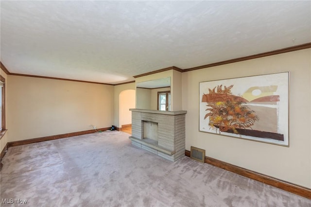 3817 Washington Park Blvd, Newburgh Heights, OH 44105 - unfurnished living room featuring arched walkways, carpet flooring, a brick fireplace, and ornamental molding