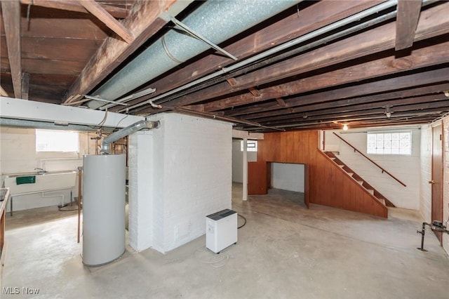 3817 Washington Park Blvd, Newburgh Heights, OH 44105 - basement with water heater, plenty of natural light, stairs, and wood walls