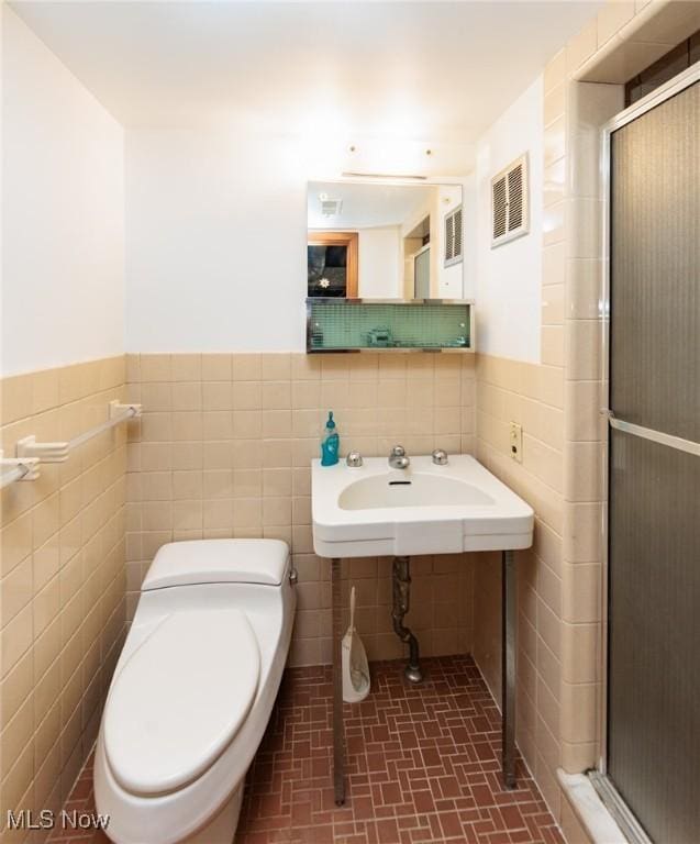 3817 Washington Park Blvd, Newburgh Heights, OH 44105 - full bath with tile walls, a shower stall, and wainscoting