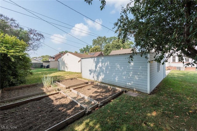 3817 Washington Park Blvd, Newburgh Heights, OH 44105 - rear view of house with a garden, a yard, and an outbuilding