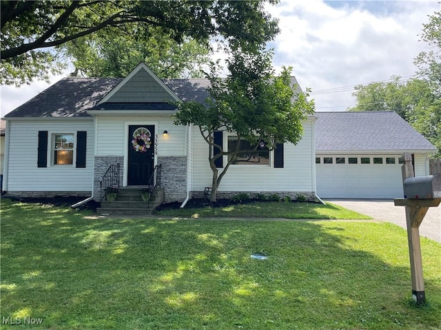 35958 Hiawatha Blvd, Eastlake, OH 44095 - view of front facade featuring entry steps, a front yard, an attached garage, driveway, and roof with shingles