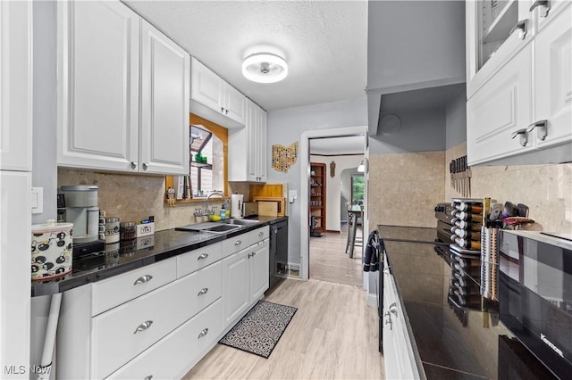 7604 Spring Garden Rd, Parma, OH 44129 - kitchen featuring stove, dark countertops, white cabinetry, and healthy amount of natural light