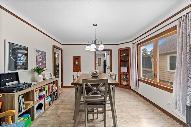 7604 Spring Garden Rd, Parma, OH 44129 - dining room featuring a chandelier, light wood finished floors, and crown molding