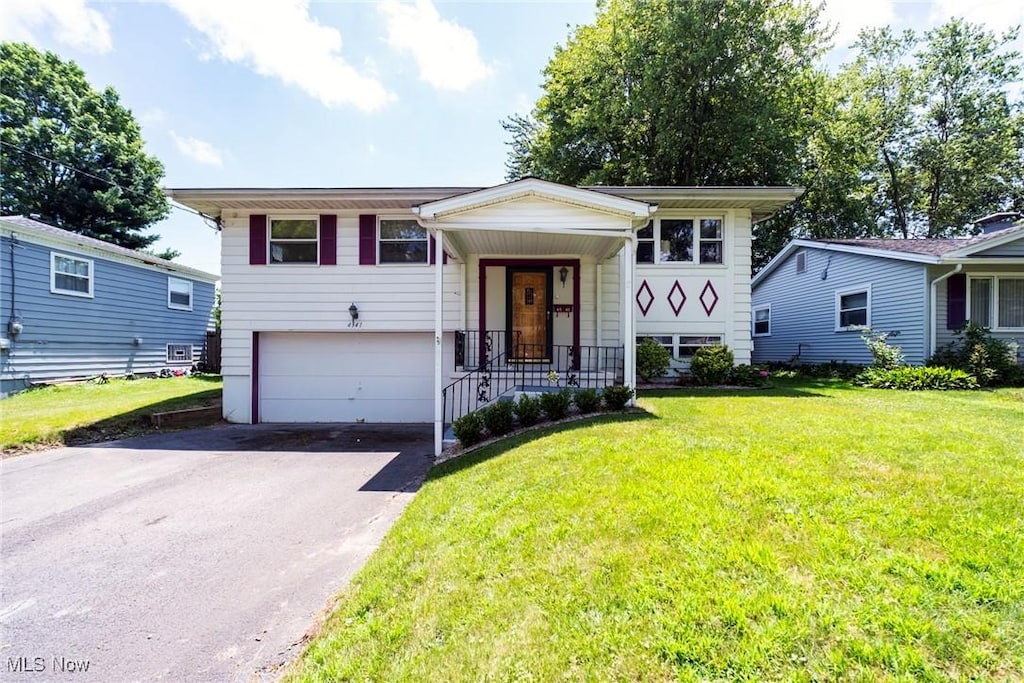 4541 Burkey Rd, Austintown, OH 44515 - bi-level home with asphalt driveway, a front yard, and a garage