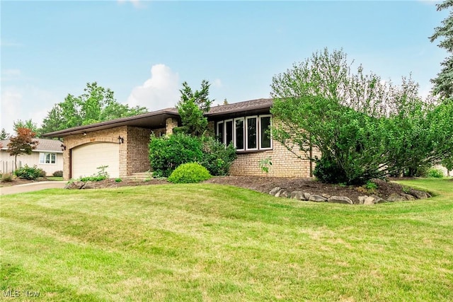 2640 Fleger Dr, Parma, OH 44134 - ranch-style home featuring brick siding, an attached garage, a front yard, and driveway