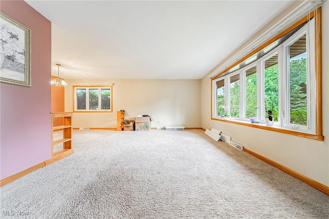 2640 Fleger Dr, Parma, OH 44134 - carpeted spare room with baseboards and a chandelier