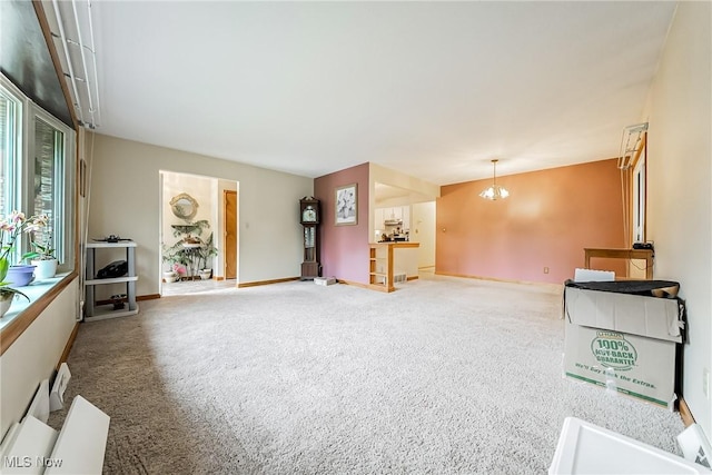 2640 Fleger Dr, Parma, OH 44134 - unfurnished living room featuring carpet, a chandelier, and healthy amount of natural light