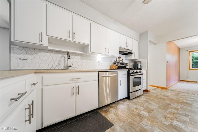 2640 Fleger Dr, Parma, OH 44134 - kitchen with stainless steel appliances, under cabinet range hood, light countertops, and backsplash