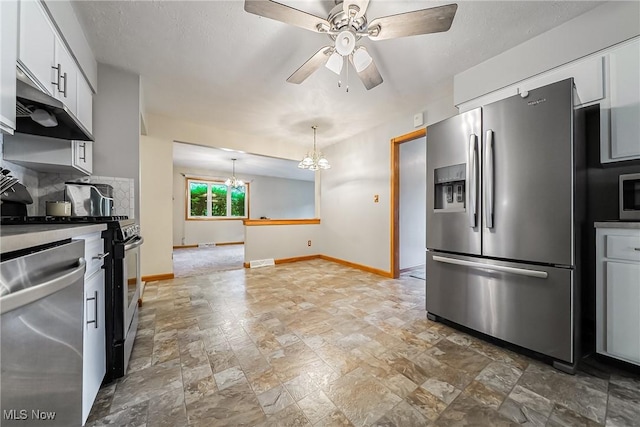 2640 Fleger Dr, Parma, OH 44134 - kitchen with stainless steel appliances, under cabinet range hood, light stone finish flooring, a ceiling fan, and white cabinetry
